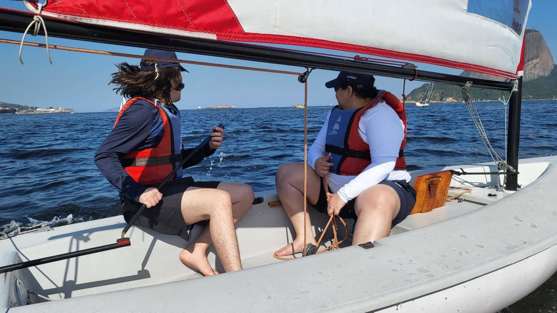 two people on a small sailboat