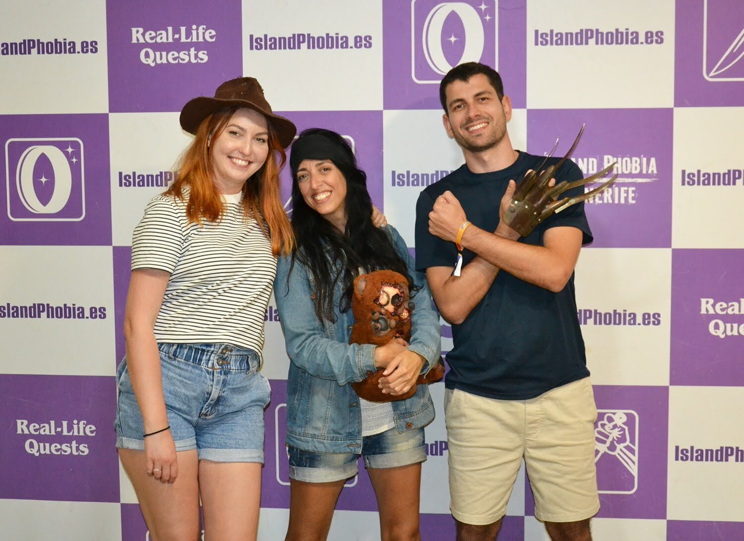 Three X-Teamers in front of a real-life quest banner