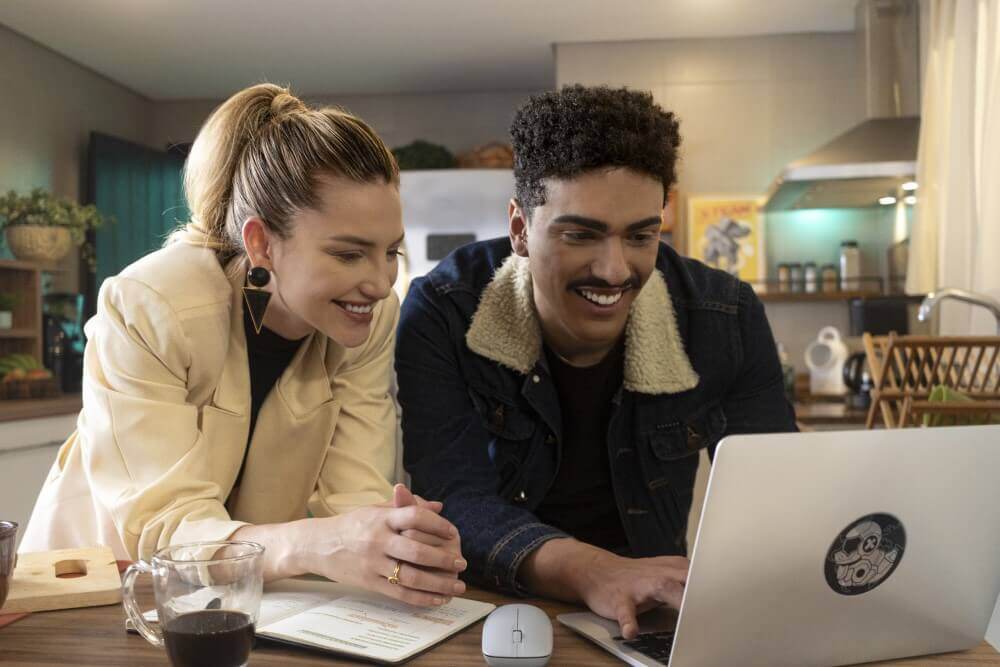 Two people looking at a laptop